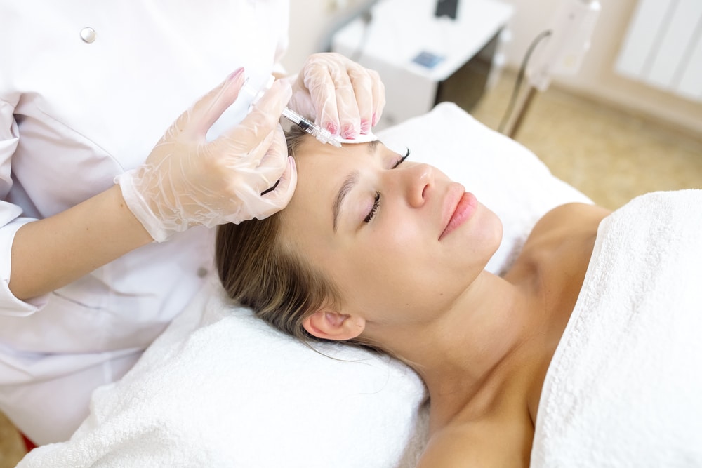 A woman getting BOTOX Cosmetic injections in her forehead